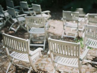 empty white wooden folding chairs
