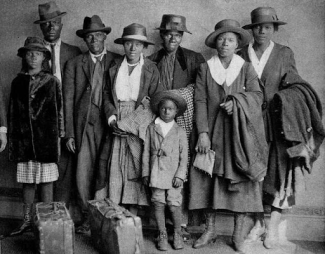 group of people standing together in formal wear