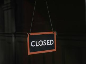 white and black stop sign that says closed