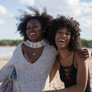 two black women holding each other and smiling