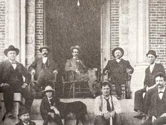 people seated in chairs in the doorway