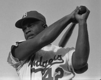 jackie robinson holding bat getting ready to swing wearing number 42 jersey
