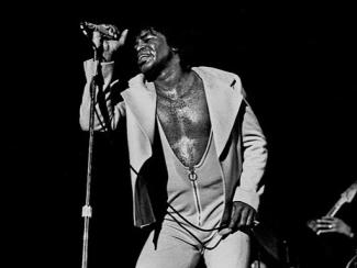 james brown singing into a microphone