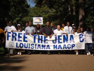 marchers holding the banner that says free the jena 6 louisiana naacp