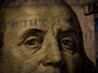 up close of benjamin franklin on a one hundred dollar bill