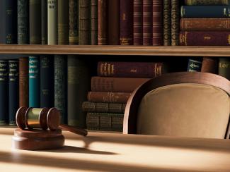 a judges gavel on a table in front of a bookshelf