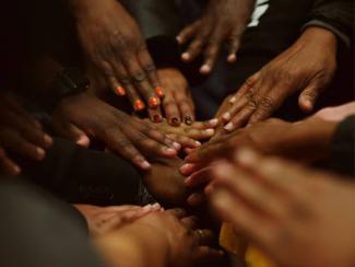 a group of people with their hands together
