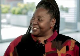 Loretta ross sitting down and smiling