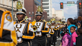 marching band marching down a street