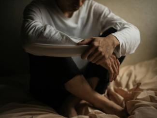 a picture of a person sitting down with legs crossed in pretzel style