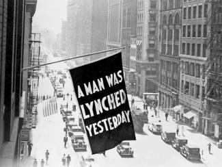 A Flag Reading 'A MAN WAS LYNCHED YESTERDAY'