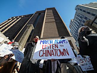 protest sign that says mayor listen to chinatown