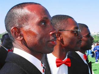 black men dressed up in tuxedos looking straight forward