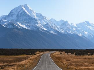 road with mountains in the background