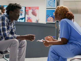 general practitioner taking patient to attend a consultation