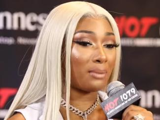 megan thee stallion holding up a microphone