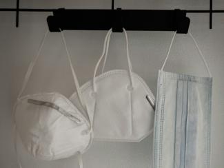 masks and white and blue towel hanging on white wall