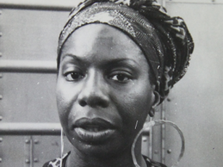 nina looking straight at the camera with an eyebrow raised