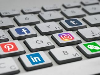 keyboard with different social media logos attached