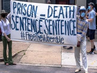 banner that says prison sentence equals death sentence