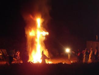 cross lit on fire and burning