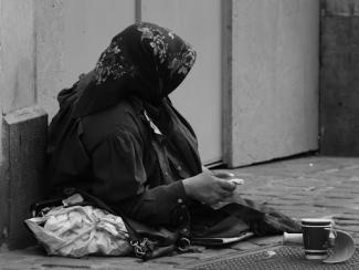 person sitting down with their head and body covered 