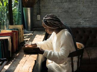 black woman sitting at a table