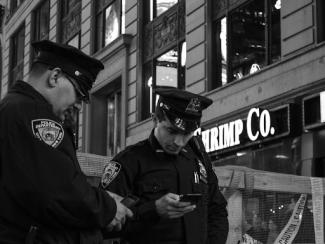 two policemen standing near a store