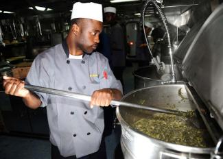 us navy seaman in a kitchen
