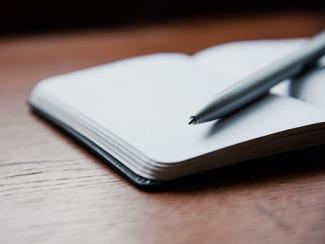 open journal with pen