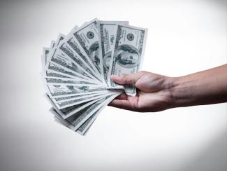 person holding 100 us dollar bills