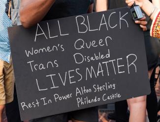 chalk sign that says all black lives matter 