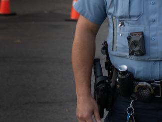 police officer standing with gun belt displayed
