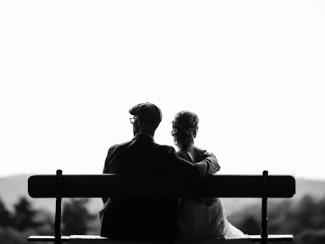 two people sitting together on a bench
