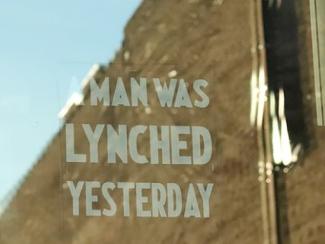 window cling that says a man was lynched yesterday