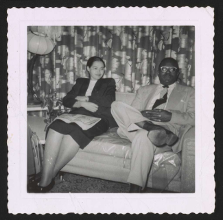rosa parks sitting down next to a man on a couch
