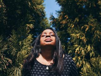 black woman outside with sun on her face