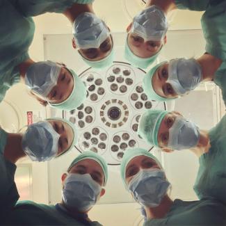 surgeons looking down on patient