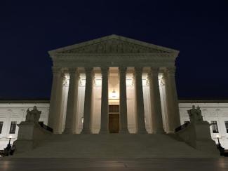 front of supreme court building at night