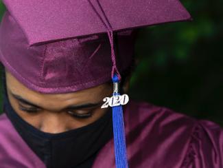 black graduate with a tassel hanging from their hat