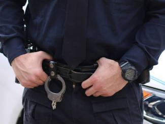 police officer grabbing belt loops of pants