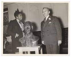 selma burke in front of a statue bust