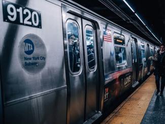 gray and red train on train station