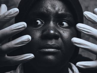 black and white photo of a person with nails on their hands
