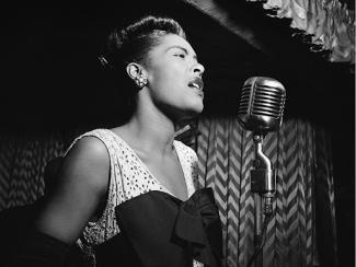 billie holiday singing into a microphone