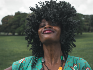 black woman with fro smiling 