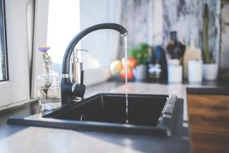 A running water faucet in a kitchen