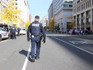 police officer walking down empty street