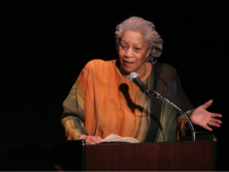toni morrison speaking in front of a microphone at a podium