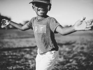grayscale photo of a boy with a shirt on that says npr on it
